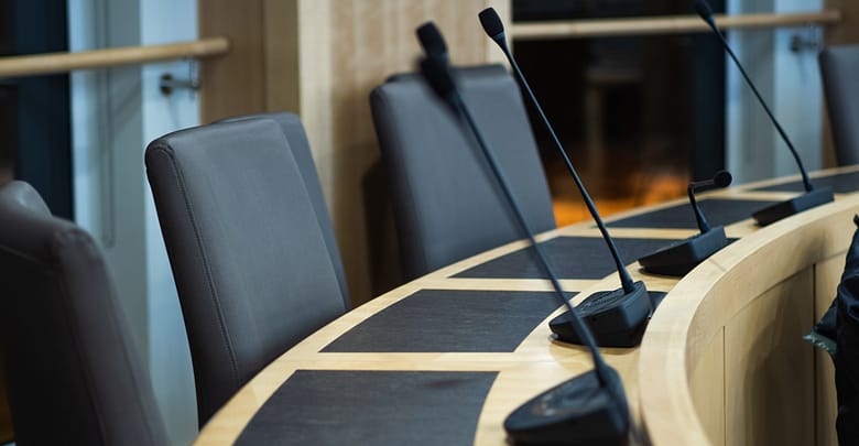 microphones and chairs in a council chamber