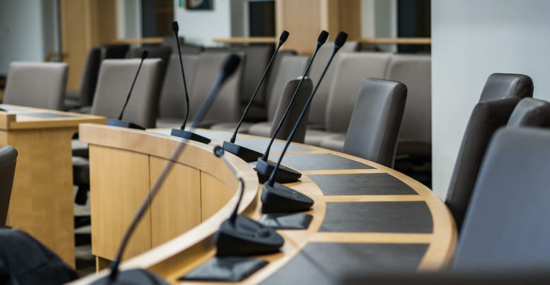 microphones and chairs in a council chamber