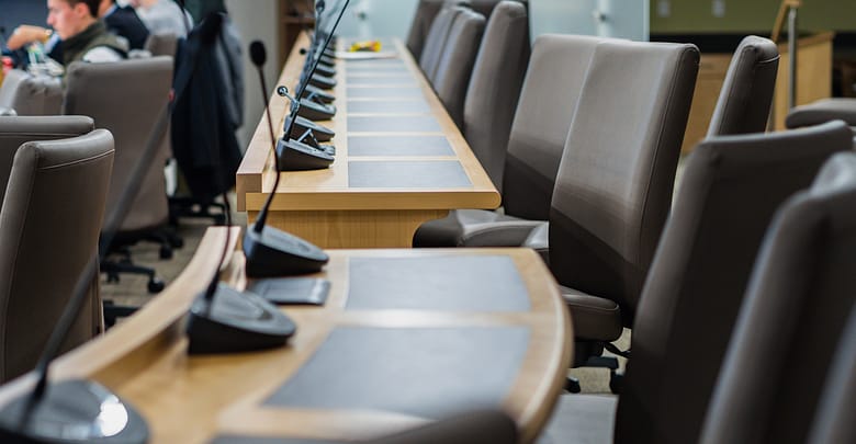 microphones and chairs in a council chamber