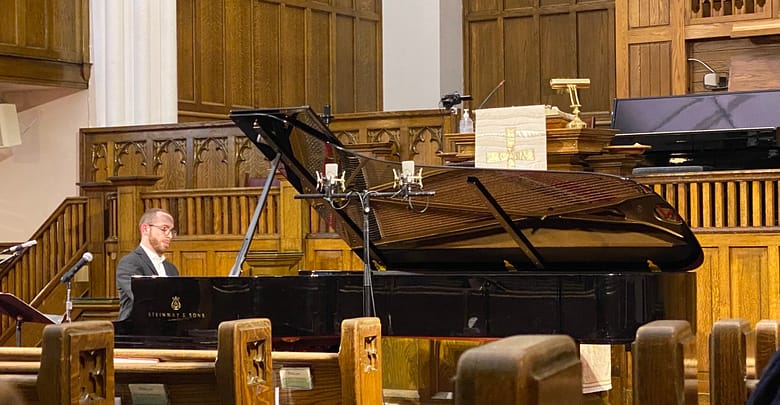 A photo of Nicolas Namoradze at the piano, performing for the ECMS.